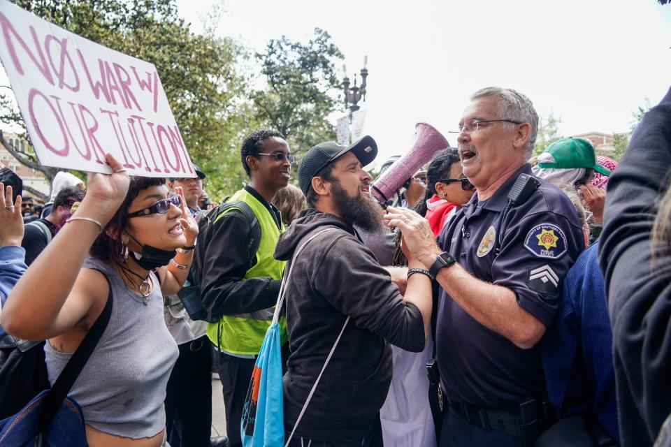 A protestor confronts a campus police officer at the University of Southern California.