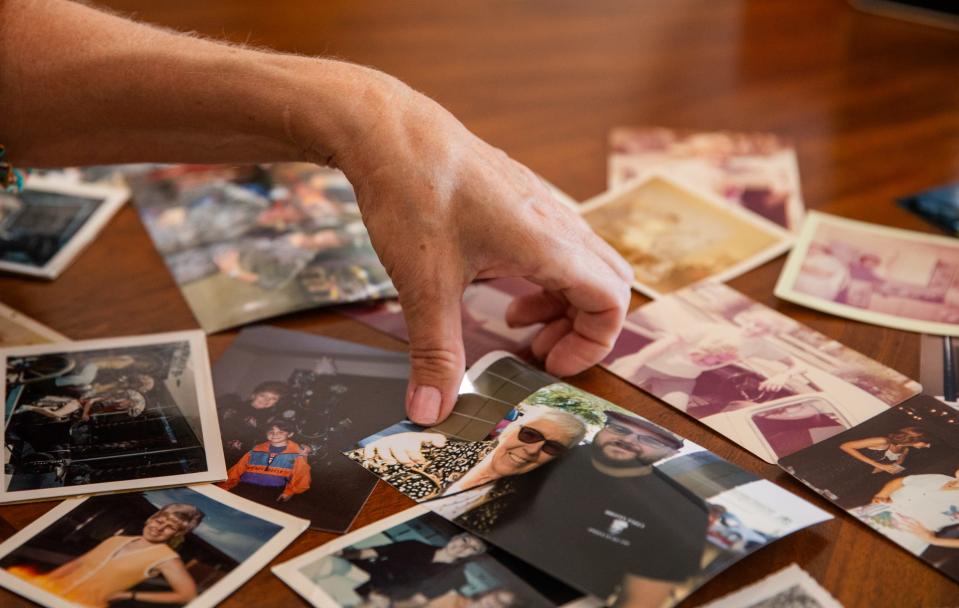 Photographs of Anita Ferretti's life spread across a table inside Michele Bixby's home in Eloy on Aug. 10, 2023.