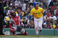 Boston Red Sox's Masataka Yoshida, right, watches his two-run home run in front of Los Angeles Angels' Logan O'Hoppe, second from left, during the sixth inning of a baseball game, Sunday, April 14, 2024, in Boston. (AP Photo/Michael Dwyer)