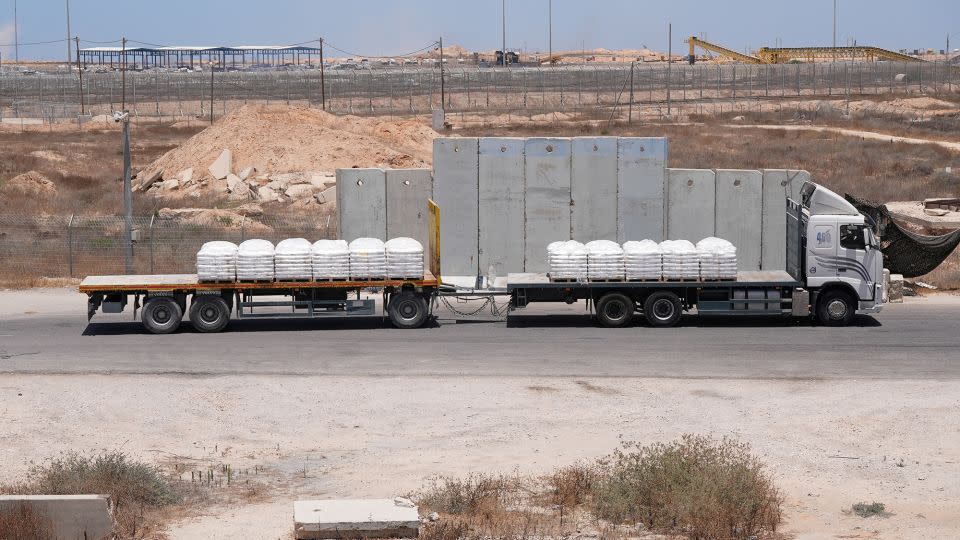 A truck carrying aid for delivery into Gaza drives through the Kerem Shalom crossing in southern Israel on Monday. - Nathan Frandino/Reuters