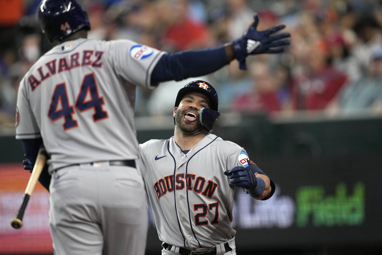 The Houston Astros' Jose Altuve (27) and Yordan Alvarez (44) celebrate after Altuve's solo home run against the Texas Rangers on Monday. (AP Photo/Tony Gutierrez)