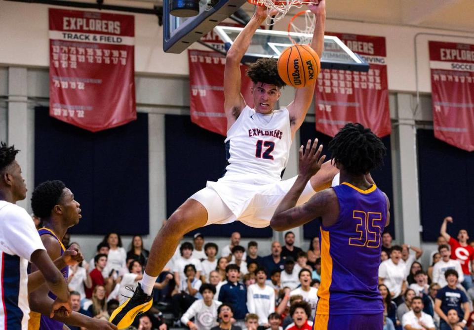 Explorers power forward Cameron Boozer (12) dunks over Camden forward Dasear Haskins (35) during the fourth period of a high school basketball game at Christopher Columbus High School in Miami, Florida, on Wednesday, January 4, 2023. D.A. Varela/dvarela@miamiherald.com