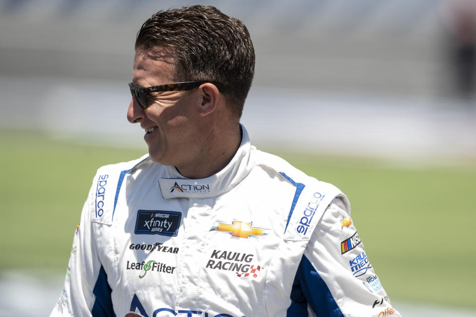 AJ Allmendinger smiles prior to a NASCAR Xfinity auto race at Charlotte Motor Speedway on Saturday, May 28, 2022, in Concord, N.C. (AP Photo/Matt Kelley)
