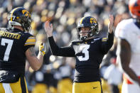 FILE - In this Nov. 23, 2019, file photo, Iowa place kicker Keith Duncan (3) celebrates with teammate Colten Rastetter after kicking a 45-yard field goal during the first half of an NCAA college football game against Illinois, in Iowa City, Iowa. Duncan was selected to The Associated Press All-Big Ten Conference team, Wednesday, Dec. 11, 2019. (AP Photo/Charlie Neibergall, File)