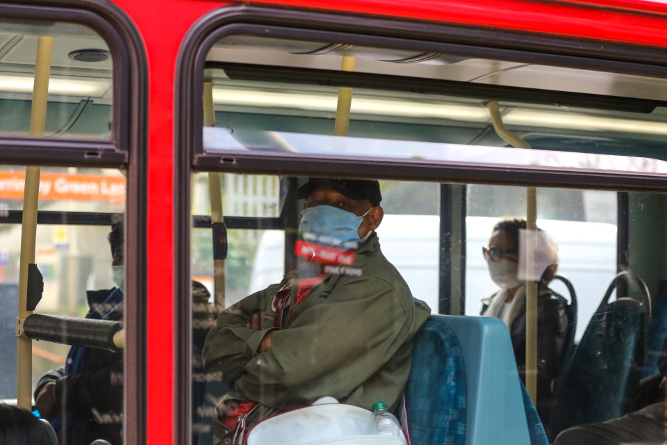 A passenger on a London bus wearing a protective mask as a preventive measure during COVID-19 outbreak. The Mayor of London has said that from Monday 20 April 2020 passengers travelling on London buses will not have to pay as a new measure to protect bus drivers from coronavirus. (Photo by Steve Taylor / SOPA Images/Sipa USA)