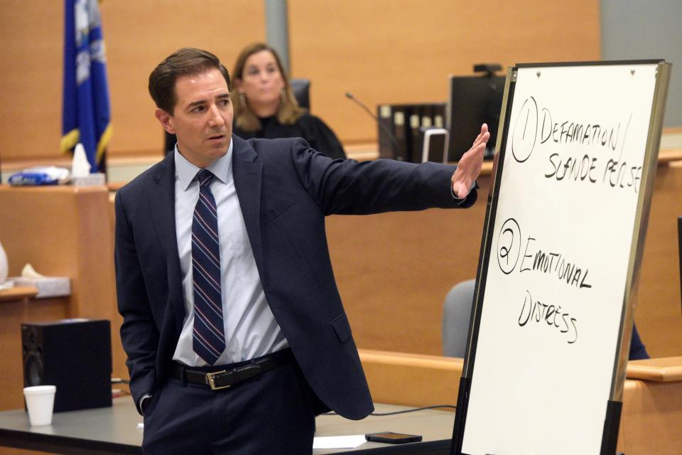 Attorney Chris Mattei points to a white board he had written on during closing statements in the Alex Jones Sandy Hook defamation trial (The News-Times)