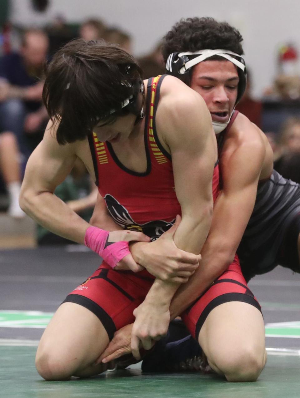 Brecksville's Mason Artino tries to break free from Stow's Robert Davis during the championship match in 132 lbs. weight class at the 2024 Suburban League tournament at Highland High School in Medina on Saturday, Jan. 27, 2024. Stow's Davis won the match.