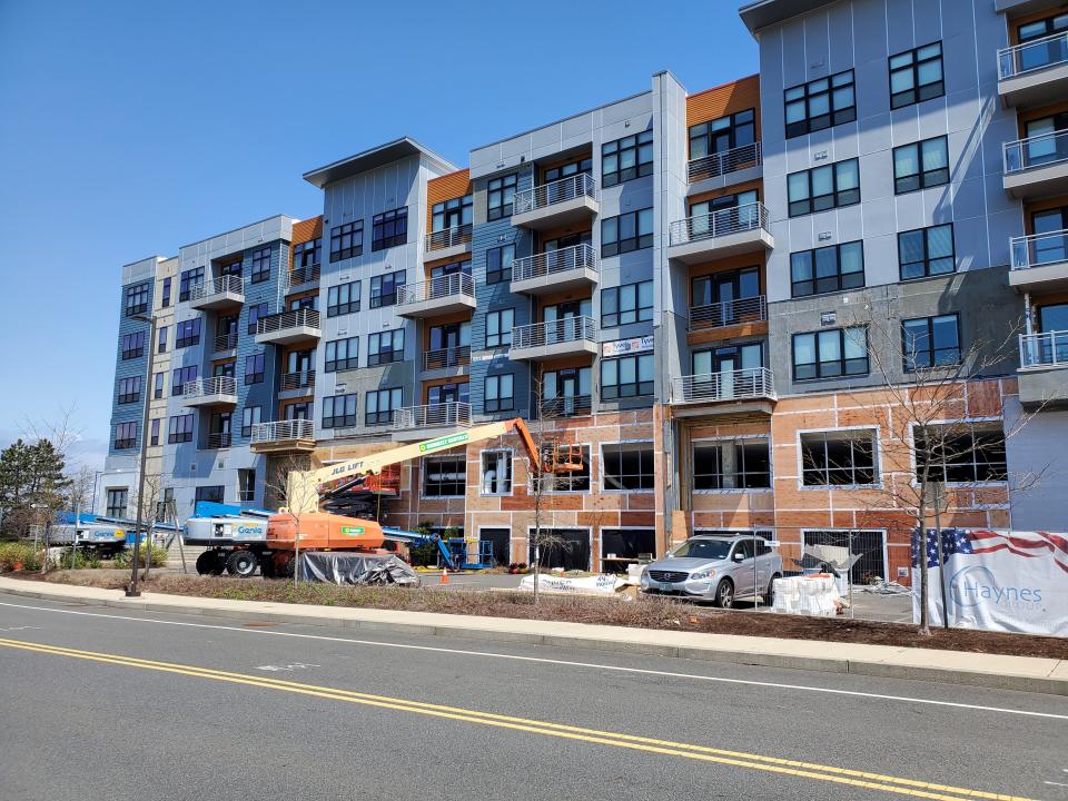 Crews removed part of the exterior façade at Meriel Marina Bay at 550 Victory Road in Quincy.