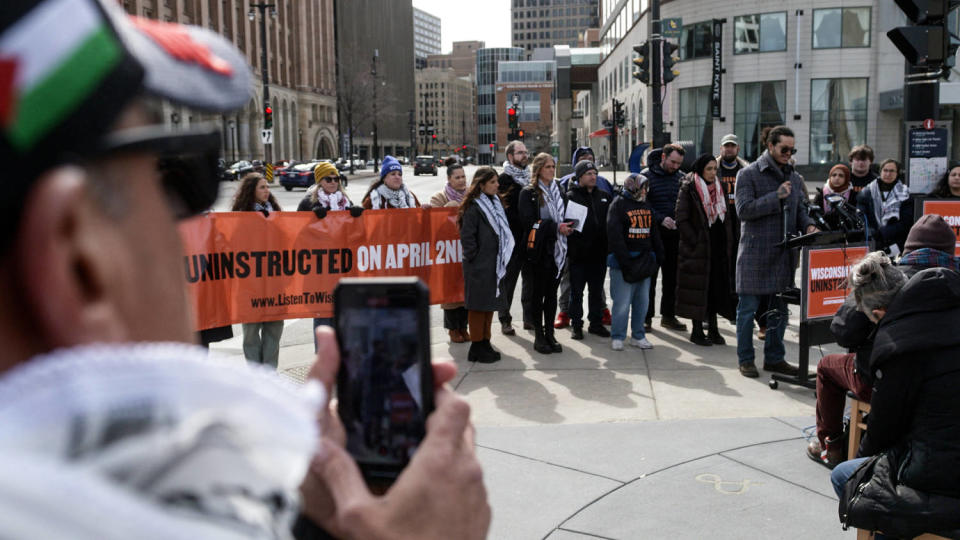 Demonstrators stand around a speaker in Milwaukee (David Gladstone / NBC News)