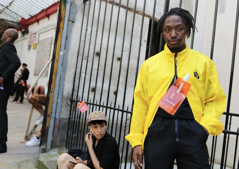 <h1 class="title">In a Nike jacket with a Heron Preston pouch</h1><cite class="credit">Photographed by Phil Oh</cite>