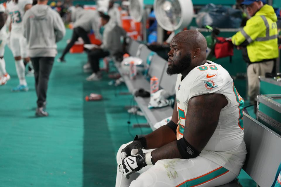 Dolphins offensive lineman Robert Jones sits dejected on the bench as Sunday night's game winds down.