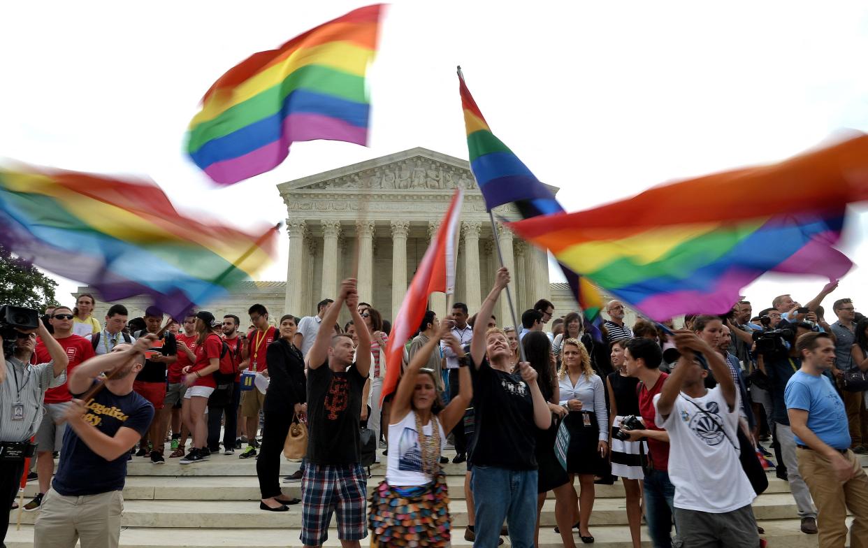 People celebrate outside the Supreme Court after the court legalized same-sex marriage in 2015. On Dec. 13, President Biden signed the Respect for Marriage Act into law.