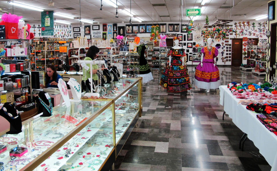 This Friday, Feb. 28, 2014 photo shows two clerks at an empty Garcia's souvenir shop in Matamoros, Mexico. In the midst of a three-year increase in American tourism in Mexico, communities along the Rio Grande are trying to win back U.S. tourists and revitalize their tourism industry. (AP Photo/Olga Rodriguez)