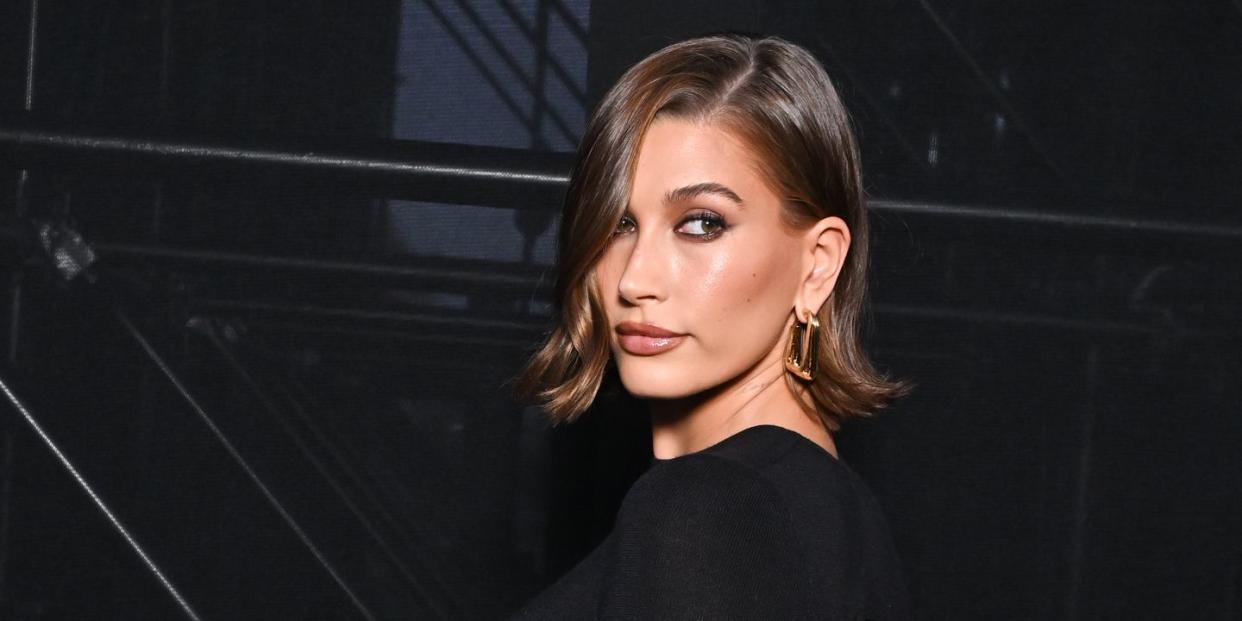 hailey bieber poses at fashion show