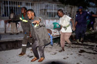 <p>People carry a victim on a stretcher out of the scene of a car bomb explosion in the capital Mogadishu, Somalia, 08 May 2017. According to reports, a car bomb exploded near a coffee shop in central Mogadishu, killing several people and injuring many others. There was no claim yet of responsibility for the blast. (Said Yusuf Warsame/EPA) </p>