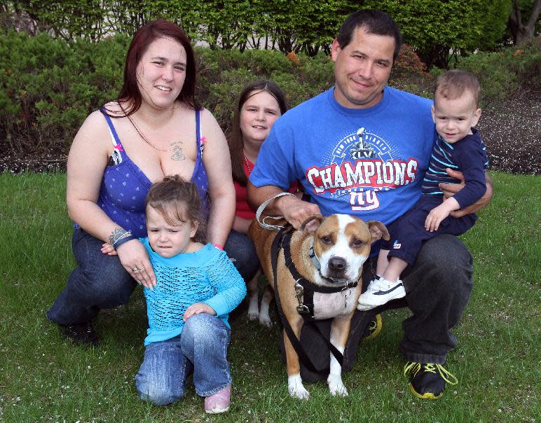 The James family of Eatontown who found their dog "Reckless" a year and half after losing it during Superstorm Sandy. Here the family poses for a photograph in Neptune. Chuck James, center, with "Reckless" and wife Elicia, left, and children Kelsey, left, Ally, center, and Liam, on knee. (AP Photo/The Asbury Park Press, Mark R. Sullivan) Mark R. Sullivan/staff photographer On Friday May 2,2014 Neptune