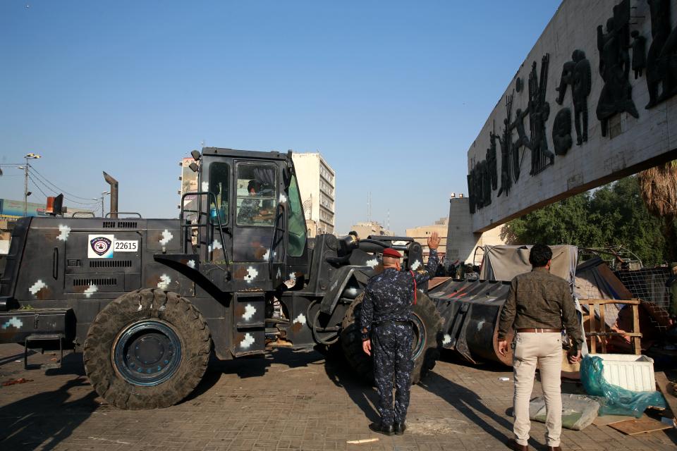 Security forces remove anti-government protesters' tents at protesters' site in Tahrir Square, Baghdad, Iraq, Saturday, Oct. 31, 2020. (AP Photo/Khalid Mohammed)