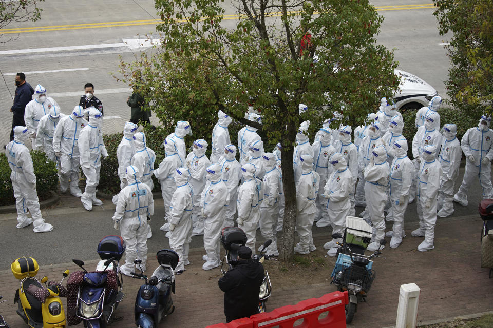 Security workers in protective suit prepare for administering COVID-19 testings for workers at the parking lot of the Shanghai Pudong International Airport in Shanghai, Monday, Nov. 23, 2020. Chinese authorities are testing millions of people, imposing lockdowns and shutting down schools after multiple locally transmitted coronavirus cases were discovered in three cities across the country last week. (AP Photo)