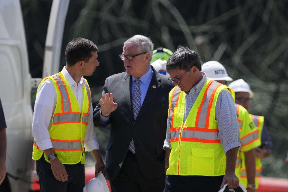 Transportation Secretary Pete Buttigieg, left, meets with Philadelphia Mayor Jim Kenney at the scene of a collapsed elevated section of Interstate 95, in Philadelphia, Tuesday, June 13, 2023. (AP Photo/Matt Slocum)