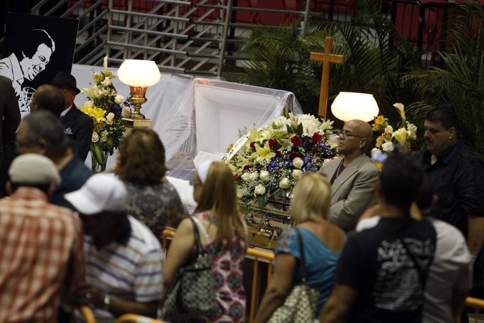 Mourners line up to pay their last respects to Cheo Feliciano during his funeral at the San Juan Coliseum in Puerto Rico, Saturday April 19, 2014. Feliciano, a member of the Fania All Stars died in a car crash early Thursday morning when he hit a light post before dawn in the northern suburb of Cupey in San Juan. (AP Photo/Ricardo Arduengo)