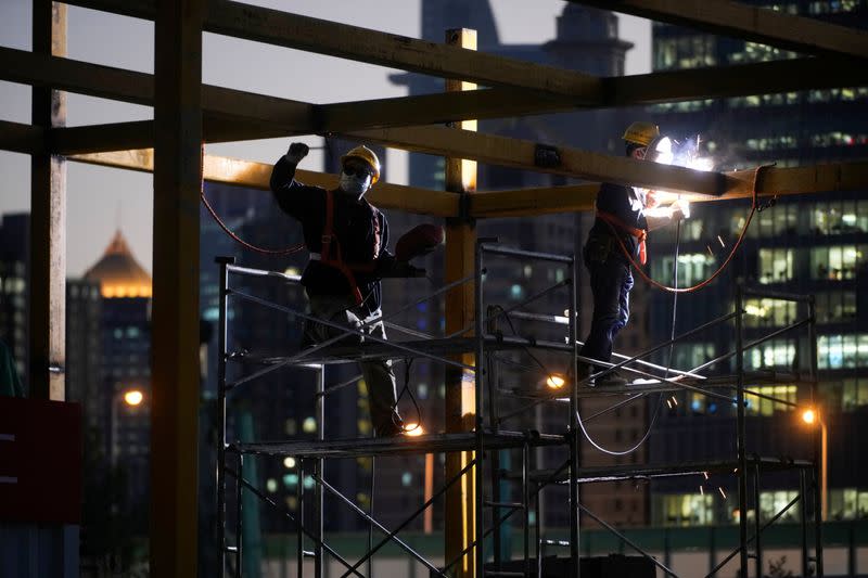 Workers work at a construction site, following the COVID-19 outbreak, in Shanghai