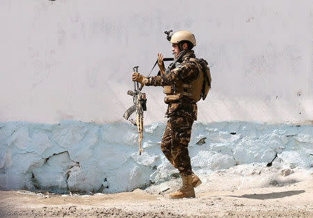 A member of Afghan security force keeps watch at the site of a blast in Kabul, Afghanistan March 17, 2018. REUTERS/Mohammad Ismail