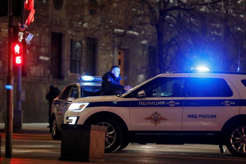 Police vehicles block a street near the Federal Security Service (FSB) building after a shooting incident, in Moscow