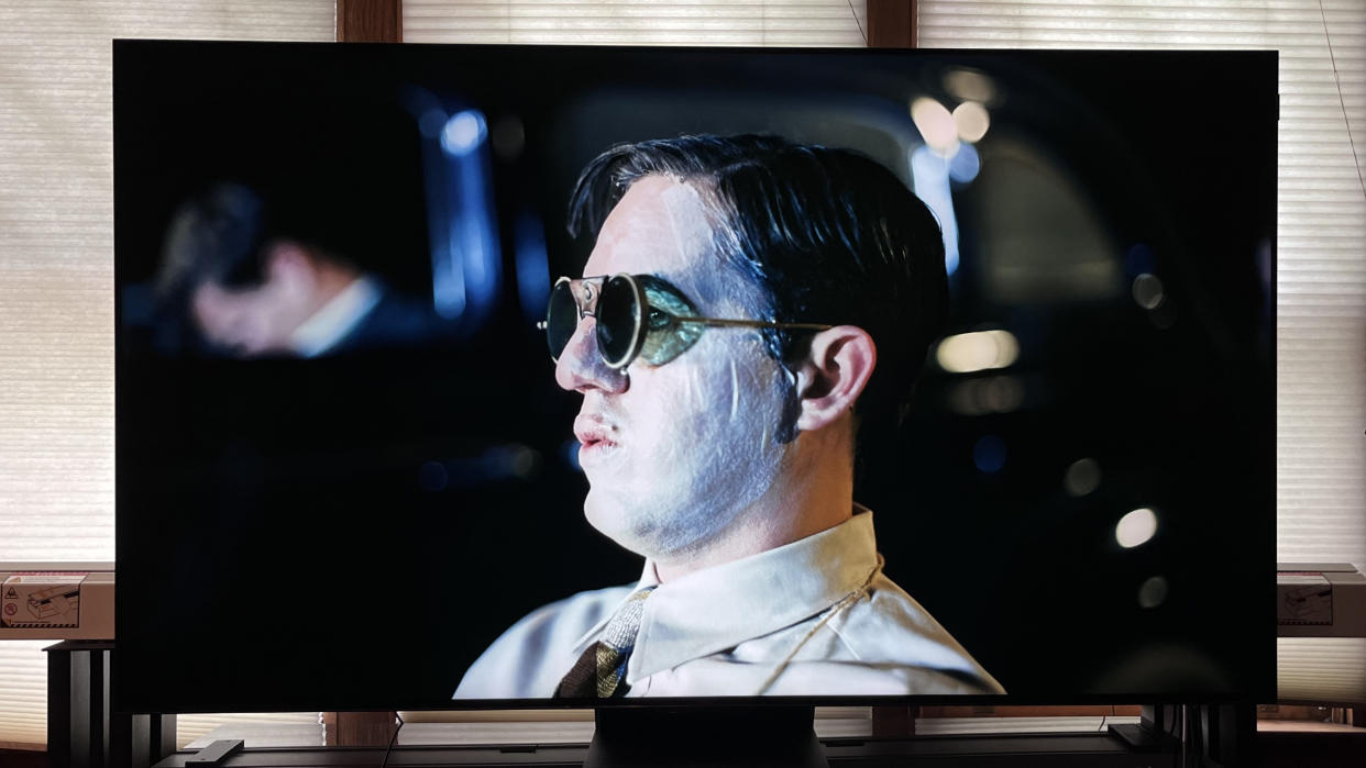  TCL QM581G showing man with sunglasses onscreen. 