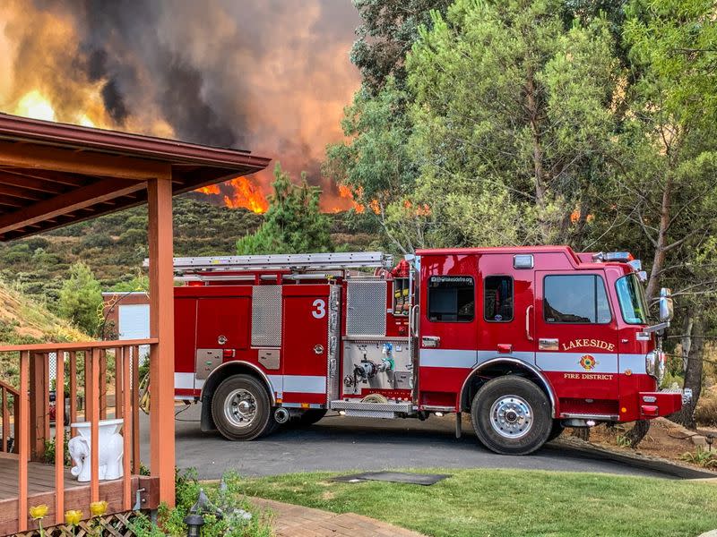 Firefighters work to extinguish a fire in Alpine, California