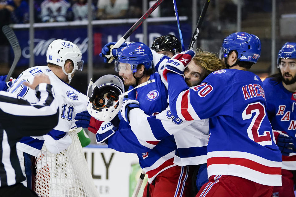 Tampa Bay Lightning's Brandon Hagel (38) fights with New York Rangers' Chris Kreider (20) and Justin Braun during the first period in Game 1 of the NHL hockey Stanley Cup playoffs Eastern Conference finals Wednesday, June 1, 2022, in New York. (AP Photo/Frank Franklin II)