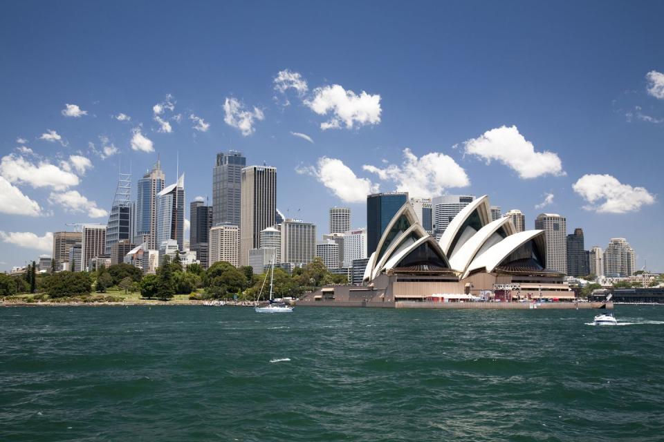 sydney opera house in sydney harbor with downtown skyline, sydney, new south wales, australia