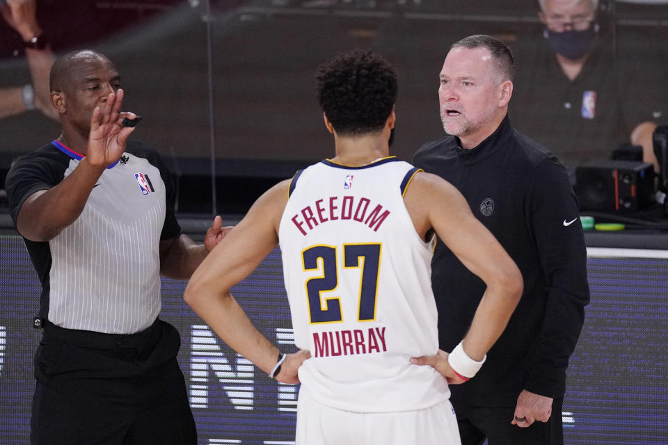 Denver Nuggets head coach Michael Malone talks with Denver Nuggets' Jamal Murray (27) during the second half of an NBA conference final playoff basketball game against the Los Angeles Lakers Saturday, Sept. 26, 2020, in Lake Buena Vista, Fla. (AP Photo/Mark J. Terrill)