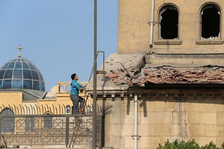 A Christian employee at Cairo’s Coptic Cathedral checks for damage from the blast after an explosion inside the cathedral in Cairo, Egypt December 11, 2016. REUTERS/Mohamed Abd El Ghany