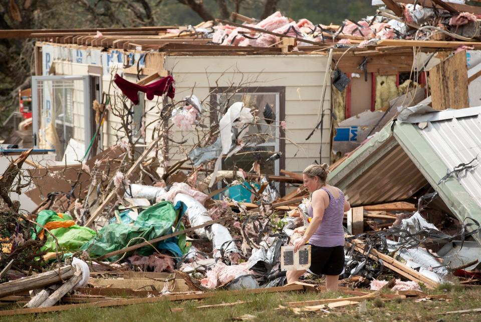 Michelle Light salvages belongings from her home in Salado, Texas, on Wednesday, a day after a tornado destroyed the house.