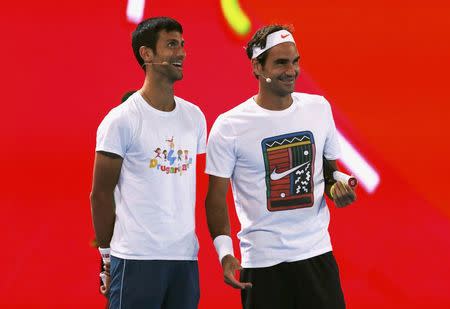 Switzerland's Roger Federer (R) and Serbia's Novak Djokovic react during a promotional event ahead of the Australian Open tennis tournament in Melbourne, Australia, January 14, 2017. REUTERS/Edgar Su