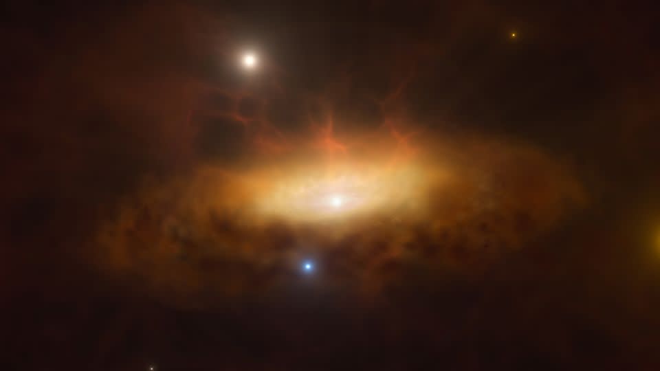 An artist's rendering shows a supermassive black hole waking up at the center of a distant galaxy.  The black hole attracts a growing disk of material as it feeds on surrounding gas, causing the galaxy to glow.  - M. Kornmesser/ESO