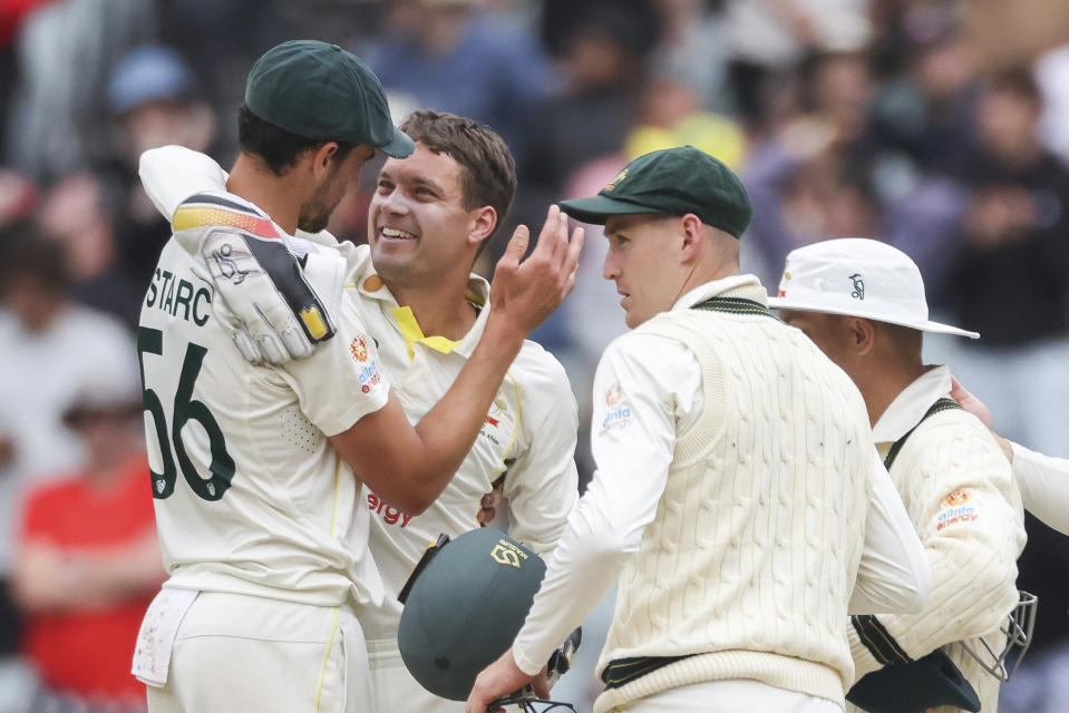 Australian Mitchell Starc, left, and Alex Carey, second left, celebrate each other after Australia defeated South Africa by an innings and 182 runs during the second cricket test between South Africa and Australia at the Melbourne Cricket Ground, Australia, Thursday, Dec. 29, 2022. (AP Photo/Asanka Brendon Ratnayake)