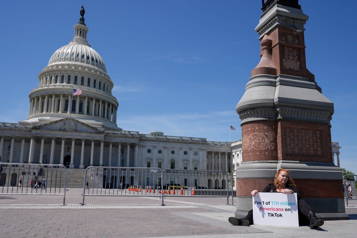 Jennifer Gay, a TikTok content creator, sits outside the US Capitol on 23 April, 2024, in Washington, DC  (The Associated Press)