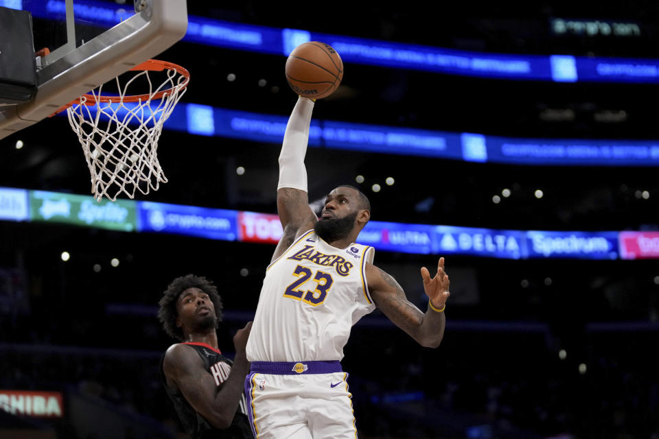Los Angeles Lakers forward LeBron James (23) dunks over Houston Rockets forward Tari Eason (17) during the second half of an NBA basketball game in Los Angeles, Sunday, Nov. 19, 2023. (AP Photo/Eric Thayer)