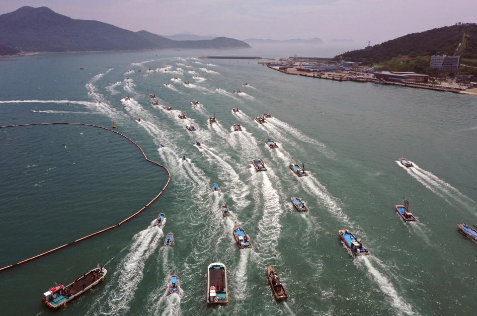 South Korean fishing boats stage a maritime parade to protest against the planned release of treated radioactive water from the wrecked Fukushima nuclear power plant into the sea, on the seas off Wando, South Korea, Friday, June 23, 2023. (Jo Nam-soo/Yonhap via AP)