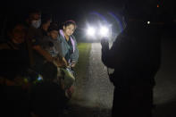 Migrants mainly from Honduras and Nicaragua stand in line after turning themselves in upon crossing the U.S.-Mexico border Monday, May 17, 2021, in La Joya, Texas. The Biden administration has agreed to let up to about 250 people a day in the United States at border crossings with Mexico to seek refuge, part of negotiations to settle a lawsuit over pandemic-related powers that deny migrants a right to apply for asylum, an attorney said Monday. (AP Photo/Gregory Bull)