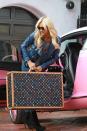 <p>This is definitely not a picture of the simple life. Wearing a blue leather biker jacket, Paris Hilton was seen stuffing her own Louis Vuitton Multicolor suitcase into a Barbie Bentley Continental GT.</p>