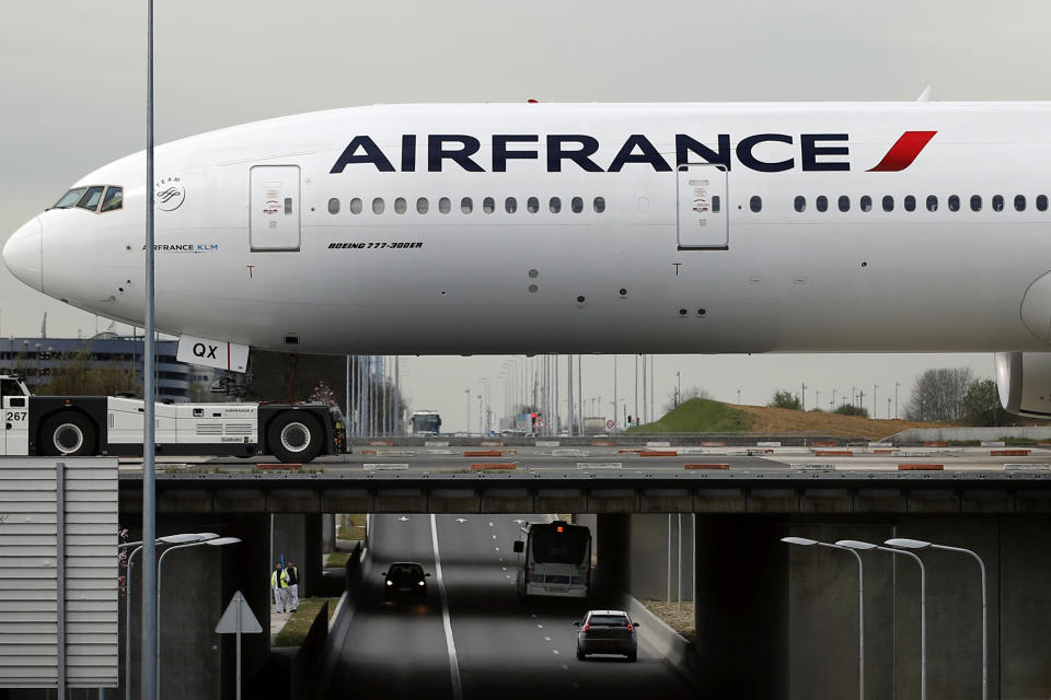 An Air France plane crosses a bridge as he prepares to take off at Paris Charles de Gaulle airport, in Roissy, near Paris, Wednesday, April 11, 2018. About 30 percent of Air France flights scheduled on Wednesday are expected to be canceled as flight crews and ground staff started a seventh day of strike. (AP Photo/Christophe Ena)