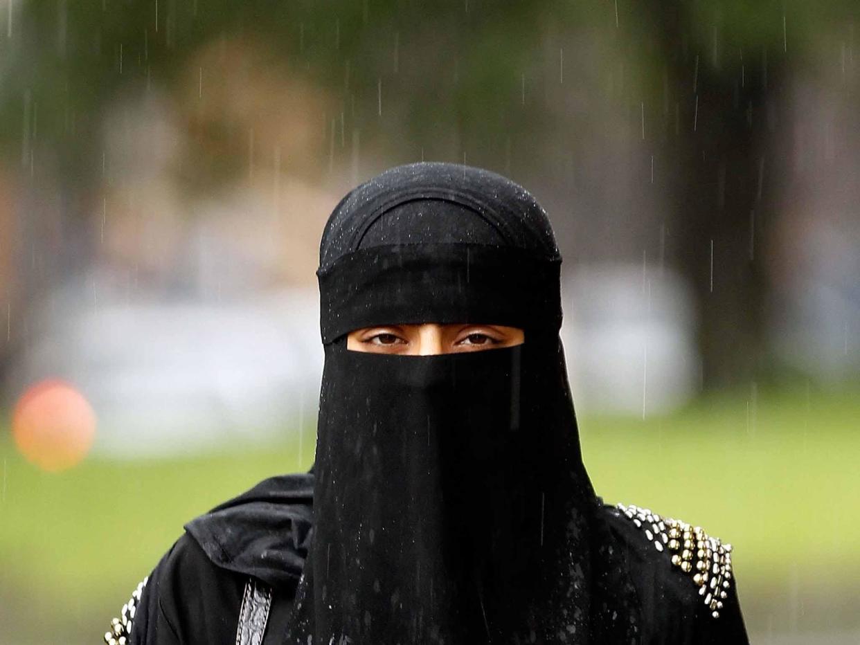 A woman wears a full-face Muslim veil - a garment to which far right groups oppose: Getty