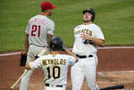 Pittsburgh Pirates' Wil Crowe, right, scores on a double by Ke'Bryan Hayes off Philadelphia Phillies starting pitcher Vince Velasquez (21) during the second inning of a baseball game in Pittsburgh, Friday, July 30, 2021. (AP Photo/Gene J. Puskar)