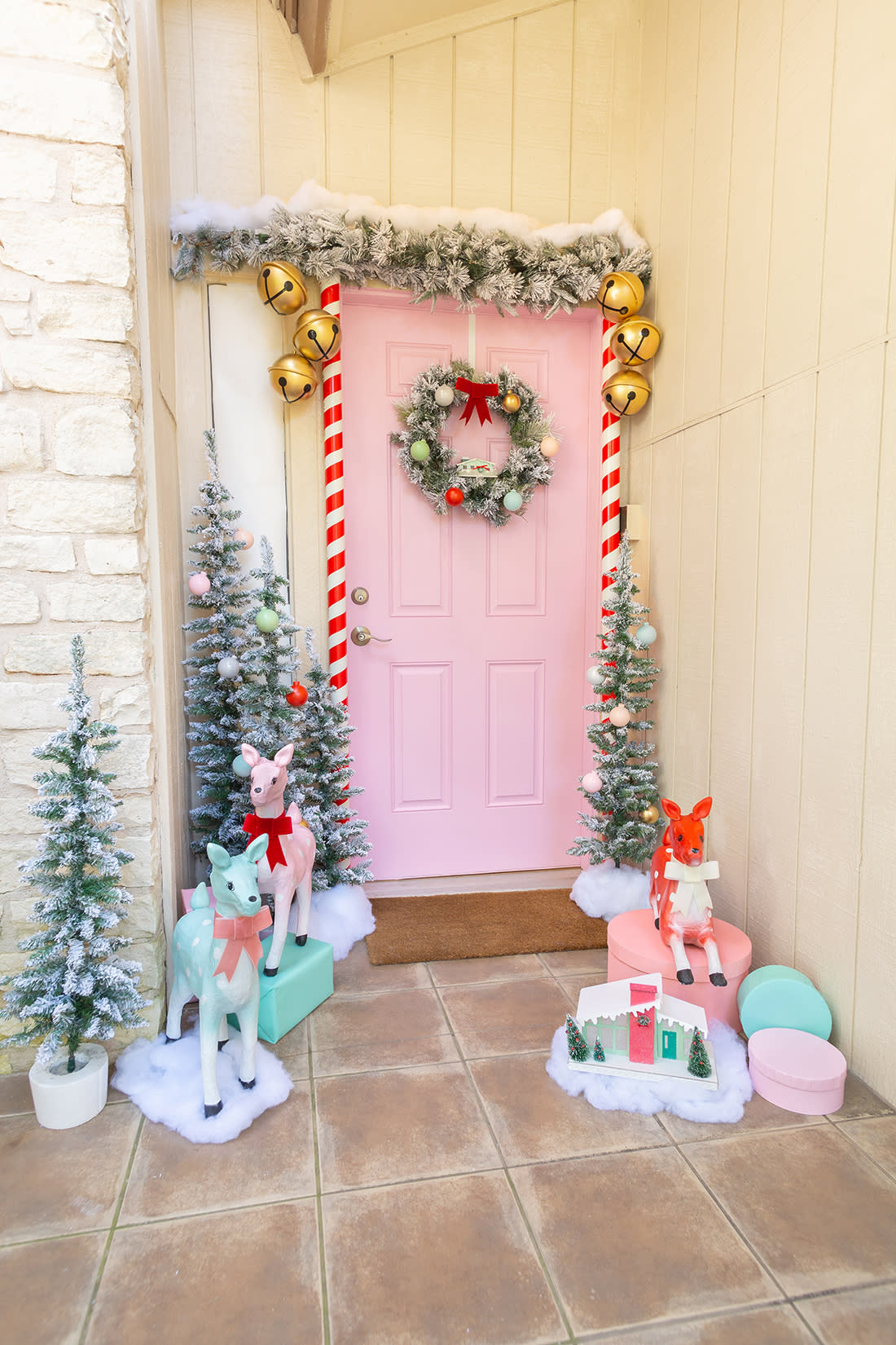 pastel pink front door with wreath, garland and cute deer  (Aww Sam)
