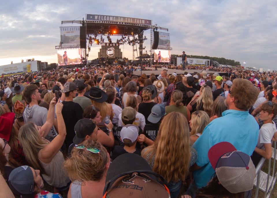 Fans in the VIP section of the Luke Bryan concert listen to the Peach Pickers, one of four acts including Luke Bryan, in Conway Township Saturday, Sept. 17, 2022.