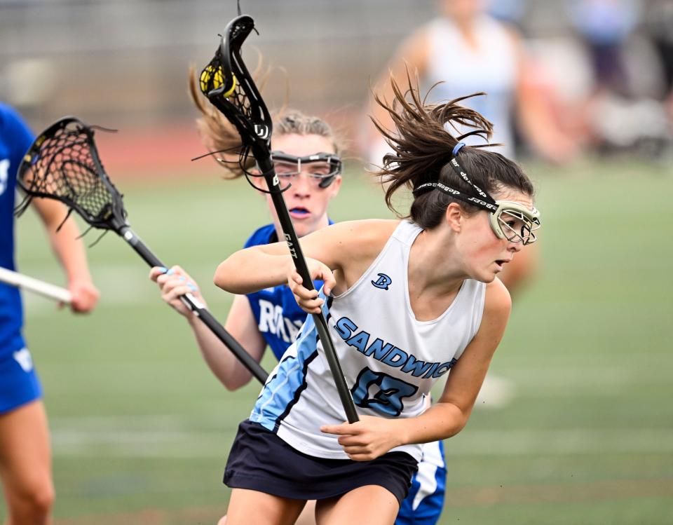 SANDWICH  6/07/23  Avery Cobban of Sandwich turns on Abigail Stauss of Georgetown in the Division 4 round of 16 girls lacrosse