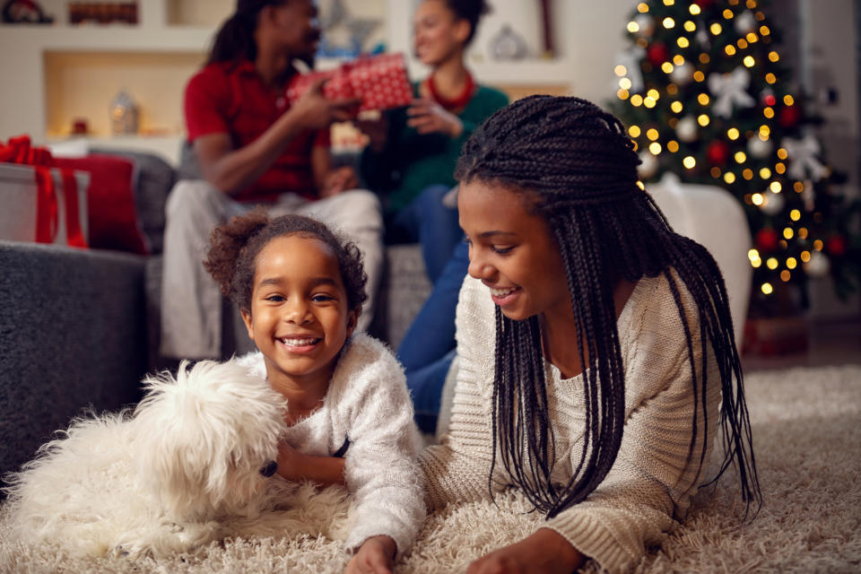 The holiday season is the perfect time to bond with your new pet by playing with them, taking walks and socializing them. (Photo: Getty Creative)