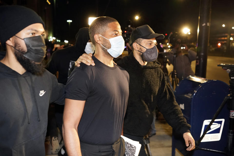 Actor Jussie Smollett, center, leaves the Cook County Jail Wednesday, March 16, 2022, after an appeals court agreed with his lawyers that he should be released pending the appeal of his conviction for lying to police about a racist and homophobic attack in Chicago. (AP Photo/Charles Rex Arbogast)